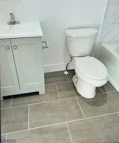 a bathroom with a toilet a sink and a mirror