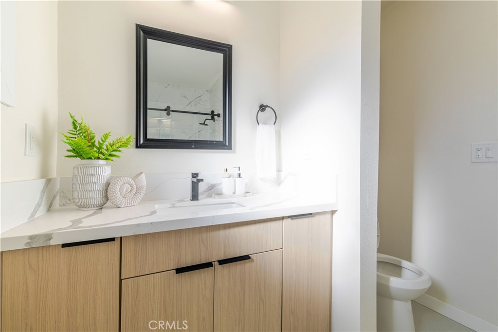 917 South Aprilia Avenue Compton, CA 90220 - Photo 8 of 24 a bathroom with a granite countertop sink and a mirror
