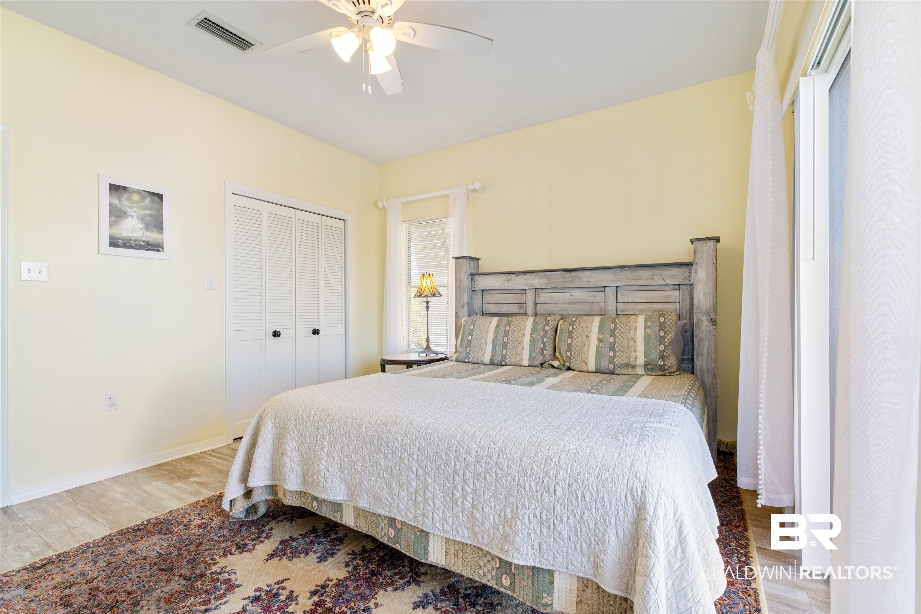 32315 River Road Orange Beach, AL 36561 - Photo 36 of 68 Bedroom with a closet, light wood like tile floors, and a ceiling fan