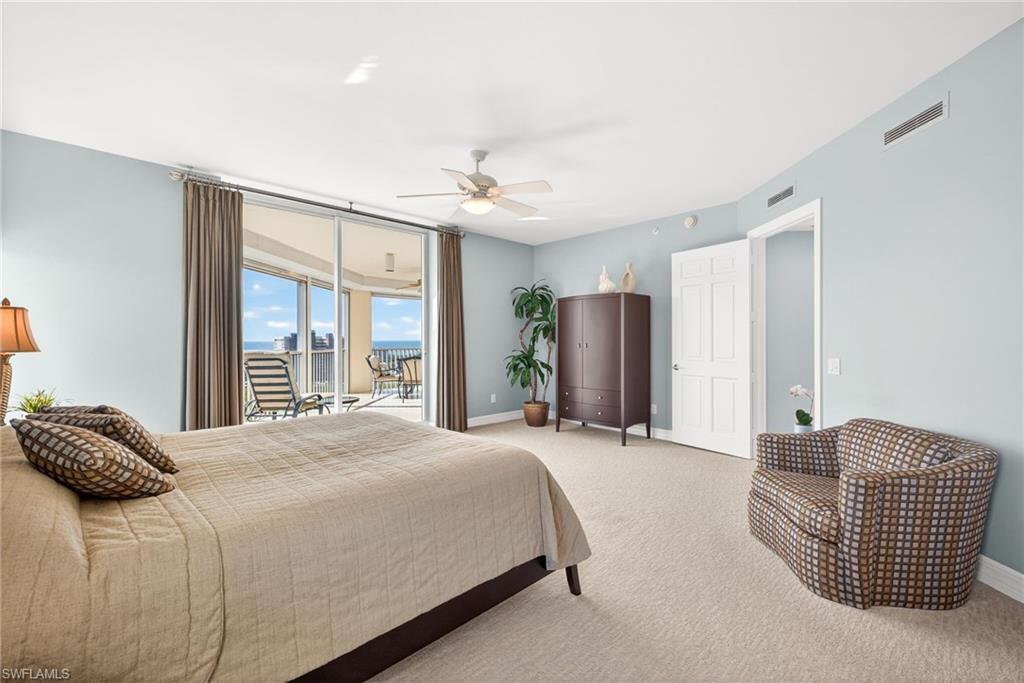 295 Grande Way, Unit 901 Naples, FL 34110 - Photo 18 of 50 a bedroom with a bed and a couch