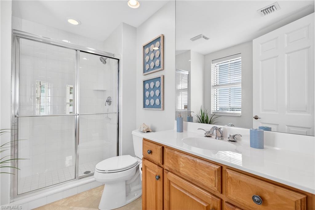 295 Grande Way, Unit 901 Naples, FL 34110 - Photo 24 of 50 a bathroom with a sink a toilet and shower