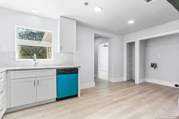 a kitchen with a sink cabinets and window