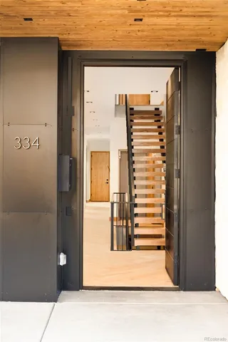 a view of a gallery with wooden floor and a living room