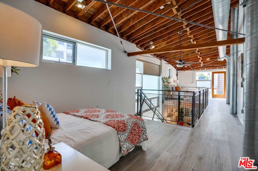 849 Pine Avenue Long Beach, CA 90813 - Photo 11 of 39 a bedroom with a bed with wooden floor