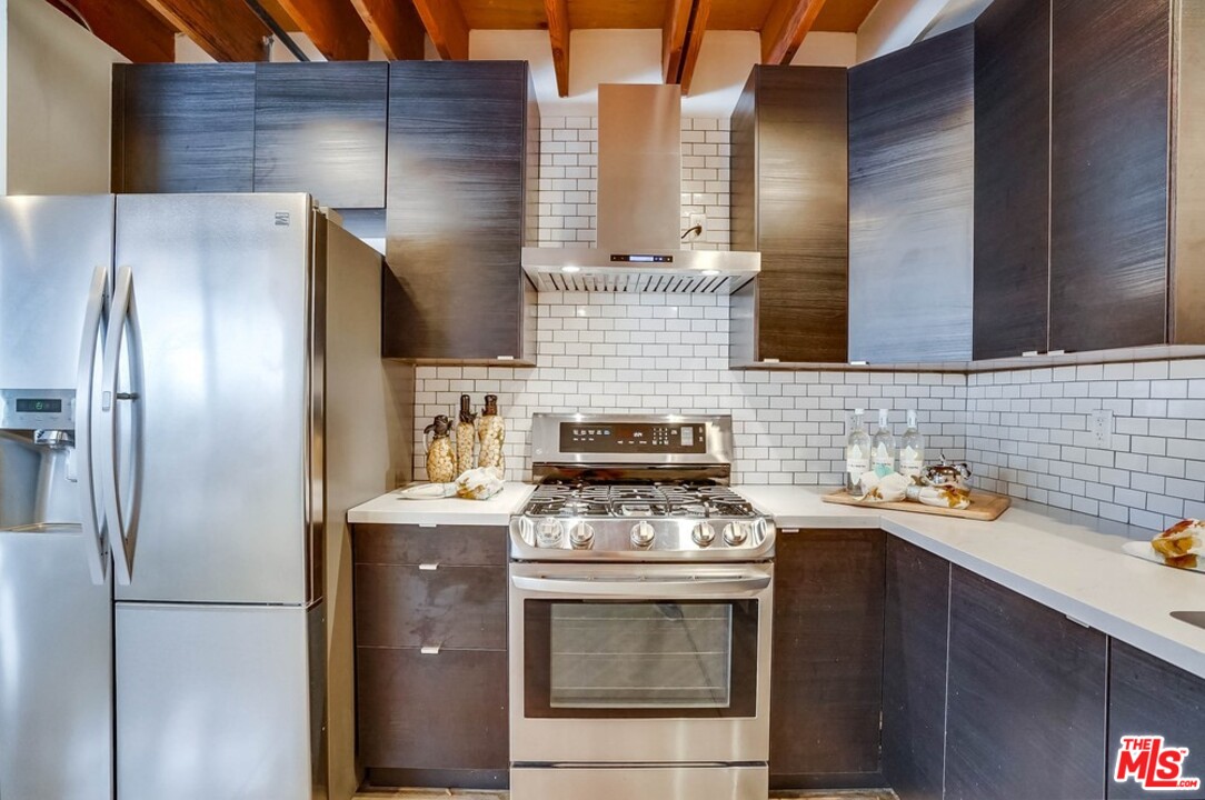 849 Pine Avenue Long Beach, CA 90813 - Photo 13 of 39 a kitchen with stainless steel appliances granite countertop a stove a refrigerator and a sink
