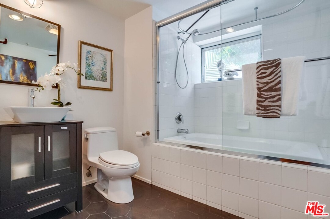 849 Pine Avenue Long Beach, CA 90813 - Photo 31 of 39 a bathroom with a granite countertop sink a toilet and shower