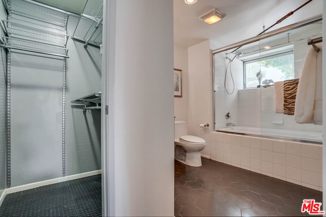 849 Pine Avenue Long Beach, CA 90813 - Photo 34 of 39 a bathroom with a granite countertop bathtub shower sink mirror and toilet
