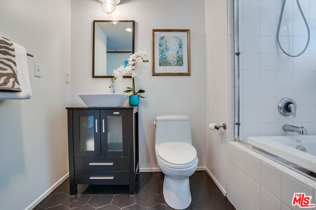 849 Pine Avenue Long Beach, CA 90813 - Photo 4 of 39 a bathroom with a toilet a sink and mirror