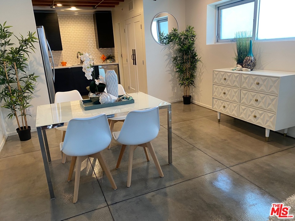 849 Pine Avenue Long Beach, CA 90813 - Photo 6 of 39 a view of a dining room with furniture and a potted plant