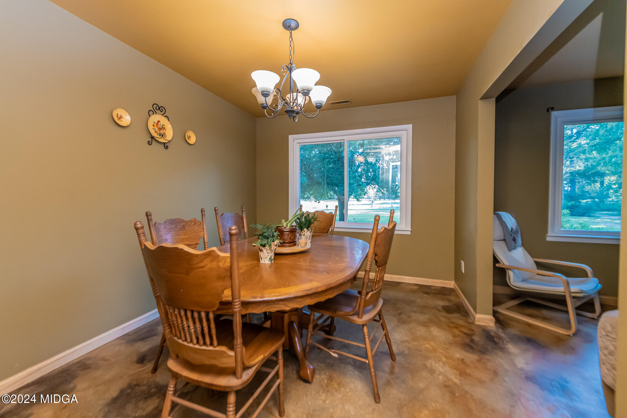 694 Cumslo Road Gray, GA 31032 - Photo 7 of 17 a view of a dining room with furniture and wooden floor