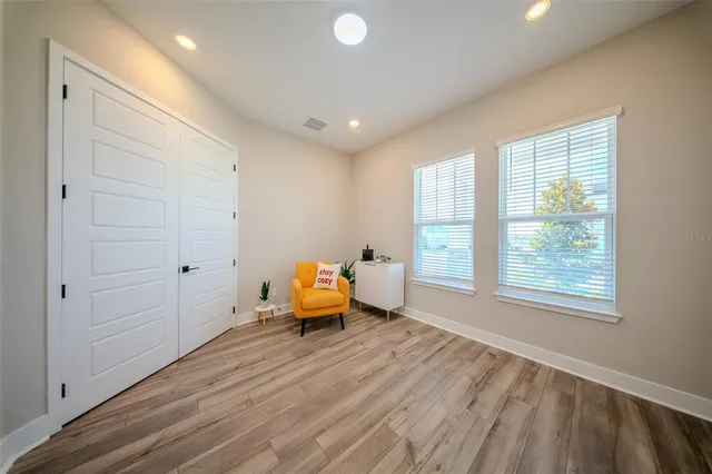 a view of a workspace with furniture and wooden floor