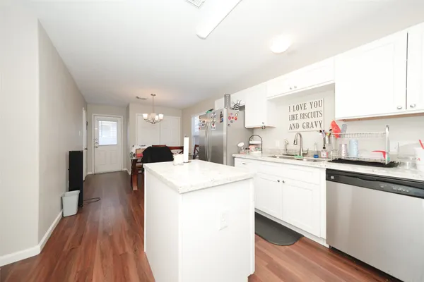 a open kitchen with sink stove and refrigerator