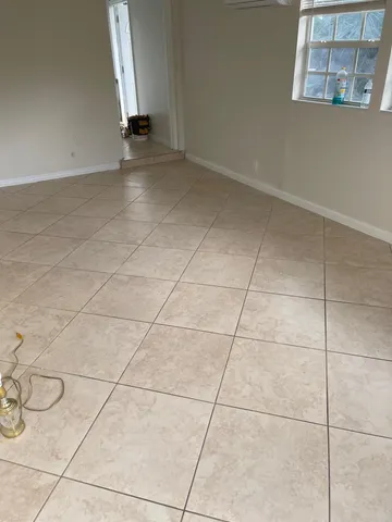 a view of a room with wooden floor and a window