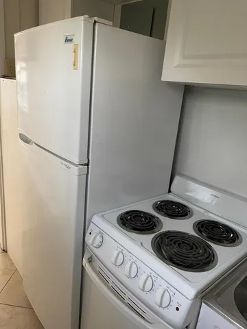 a white refrigerator freezer and a stove