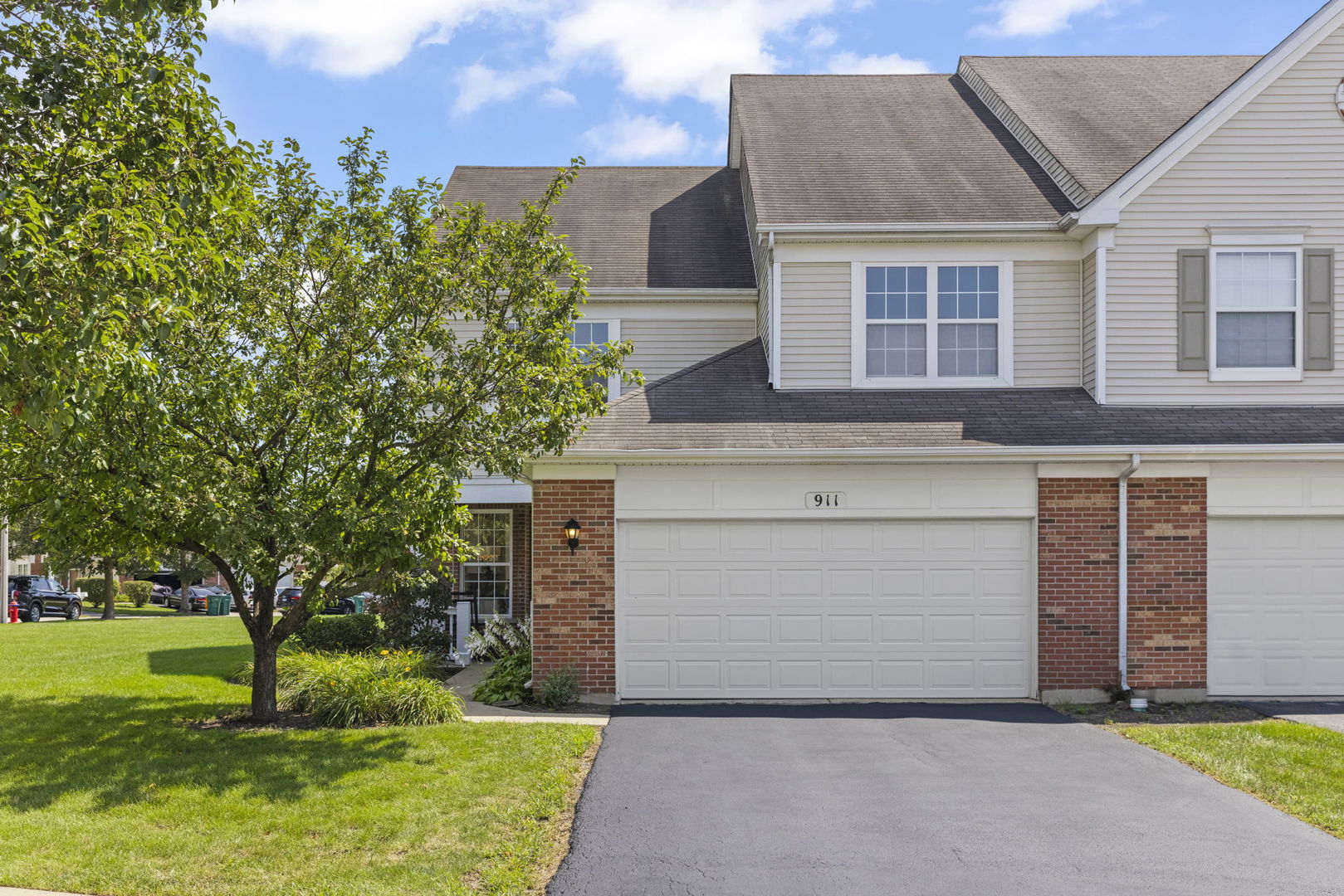a front view of a house with a yard and garage