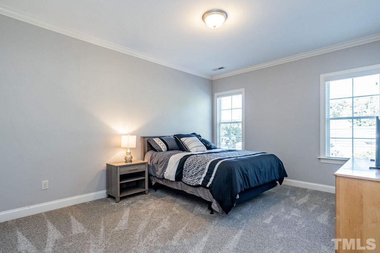 8035 Brandyapple Drive Raleigh, NC 27615 - Photo 23 of 30 Second Floor Bedroom with ceiling crown and new carpet.