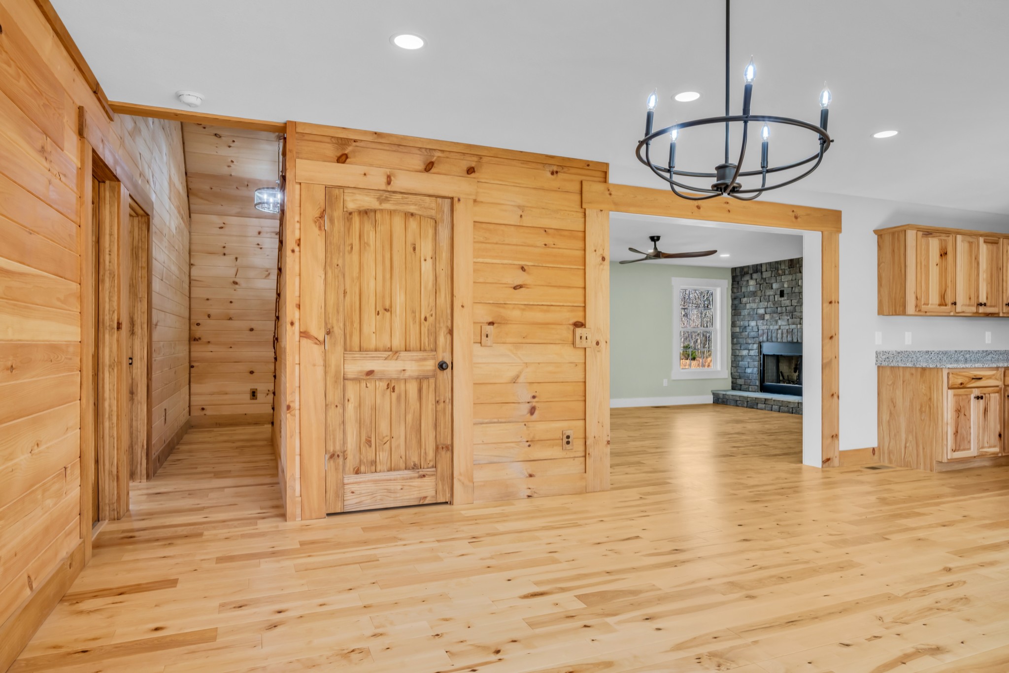 718 Darrell Rye Road Erin, TN 37061 - Photo 12 of 38 a view of a hallway with wooden floor and chandelier