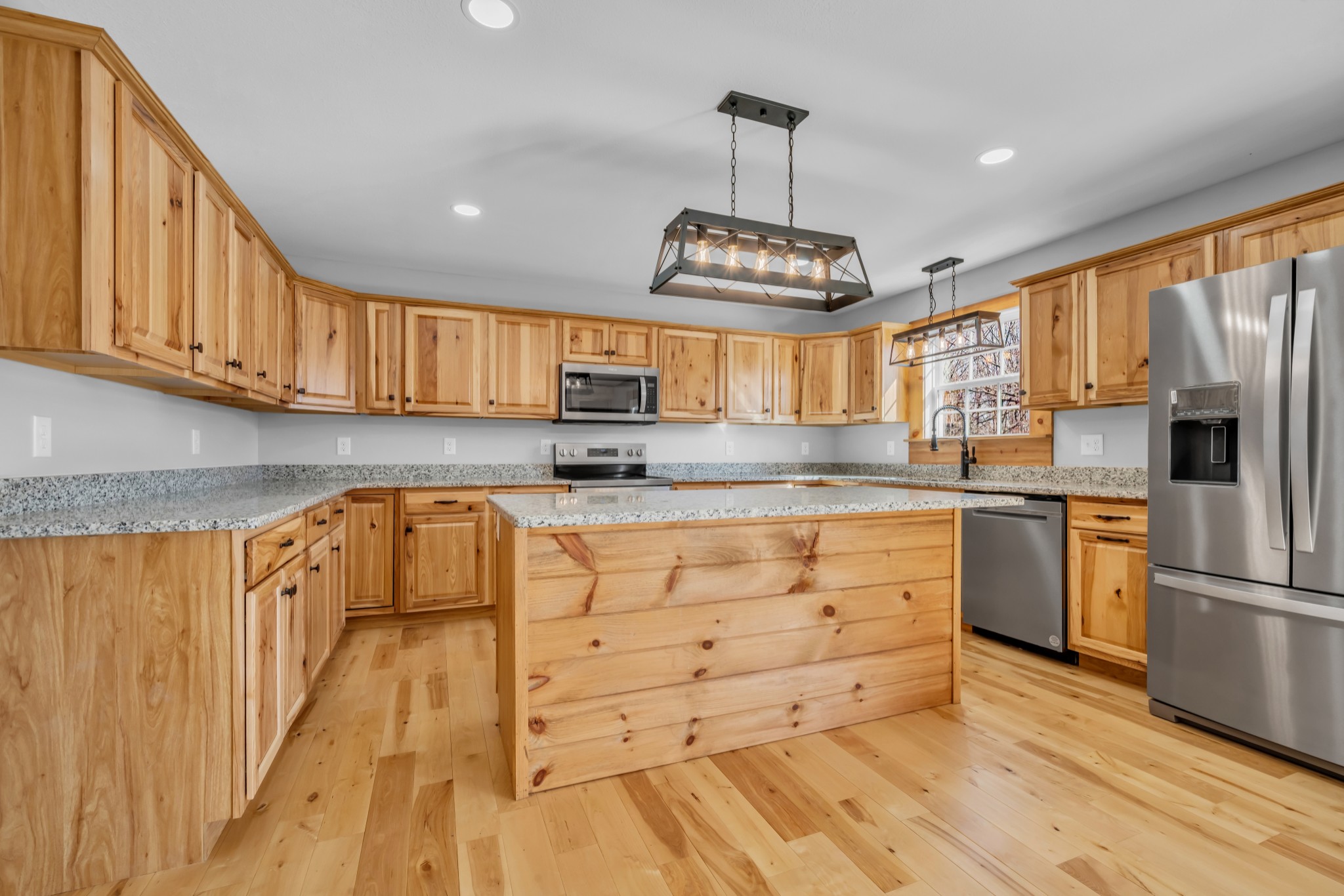 718 Darrell Rye Road Erin, TN 37061 - Photo 15 of 38 a kitchen with stainless steel appliances granite countertop a refrigerator a stove a sink dishwasher and wooden cabinets with wooden floor