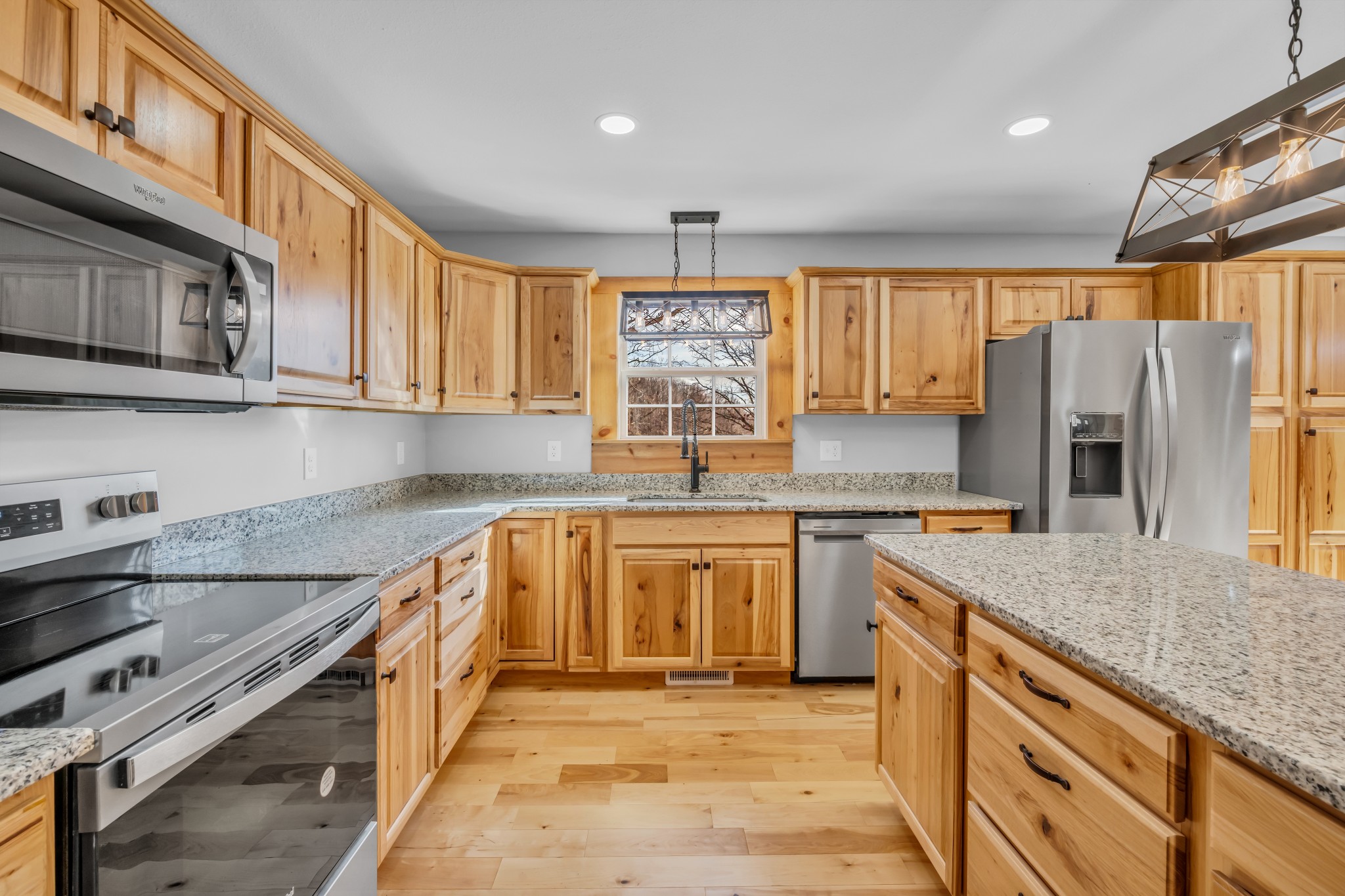 718 Darrell Rye Road Erin, TN 37061 - Photo 16 of 38 a kitchen with stainless steel appliances granite countertop a sink stove and refrigerator