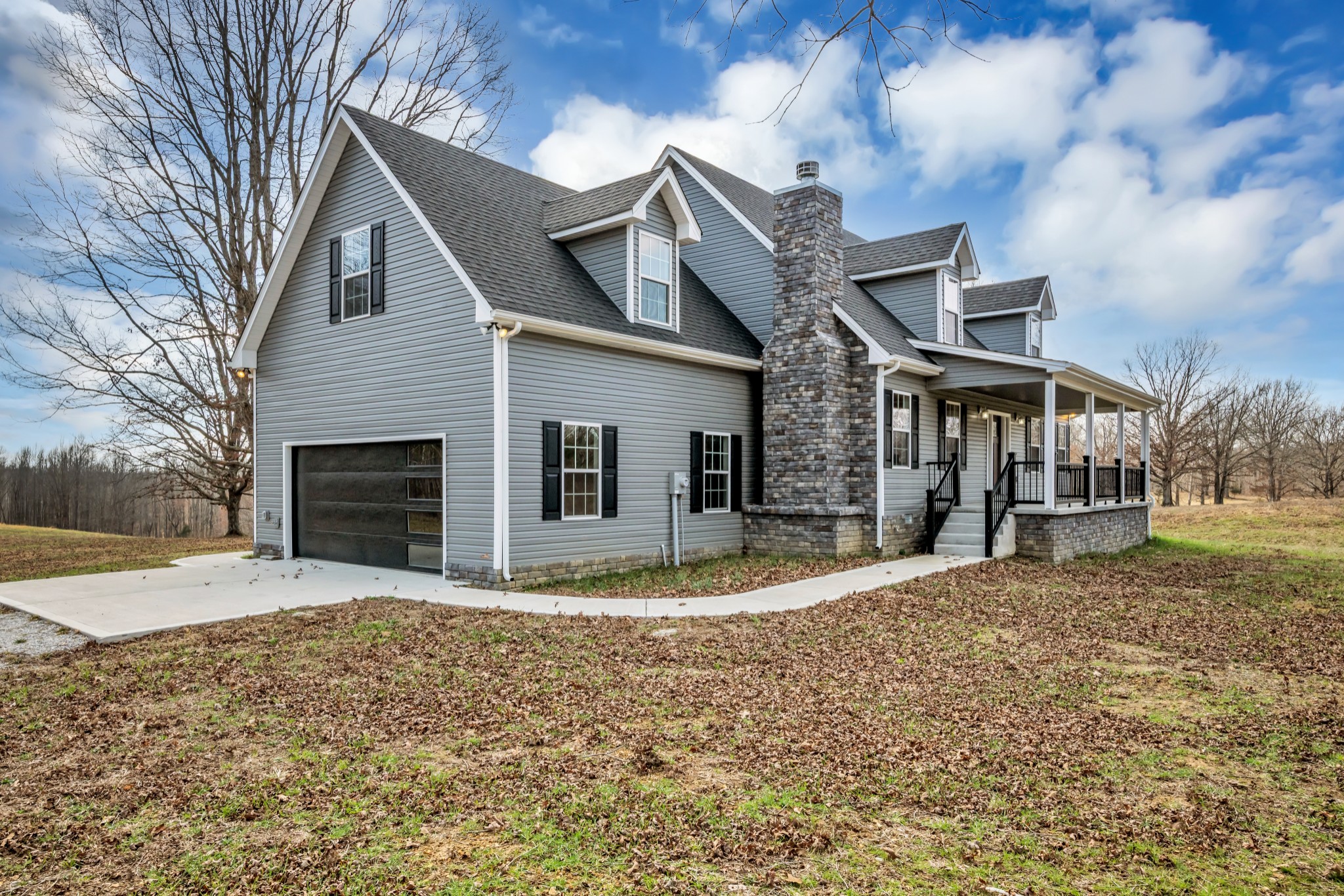 718 Darrell Rye Road Erin, TN 37061 - Photo 4 of 38 a front view of a house with a yard and garage