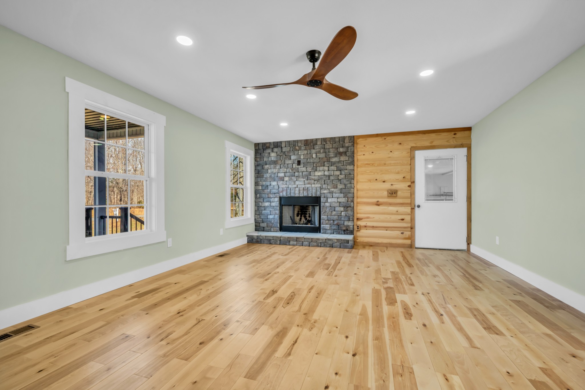 718 Darrell Rye Road Erin, TN 37061 - Photo 8 of 38 wooden floor in an empty room with a fireplace