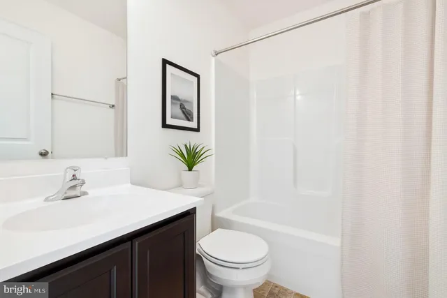 a bathroom with a sink a toilet and tub