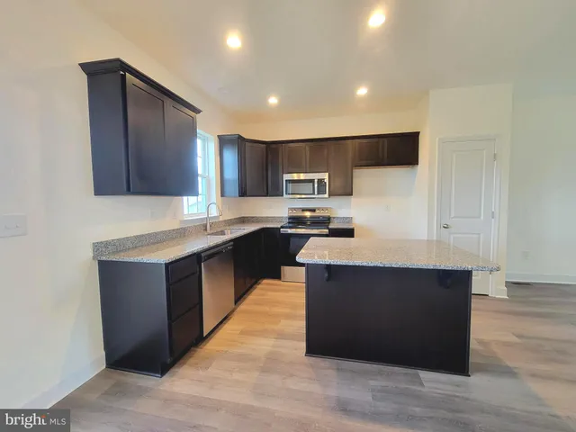 a kitchen with wooden cabinets and a sink