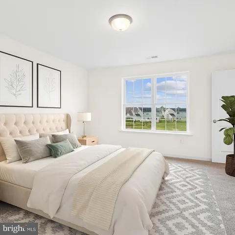 a bedroom with double bed and a window