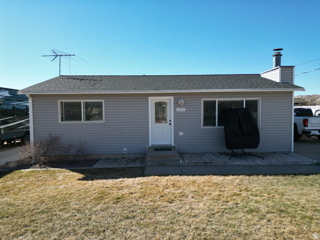 1852 East 3500th Street South Vernal, UT 84078 - Photo 46 of 46 View of front of house featuring a front yard, a chimney, roof with shingles, and entry steps