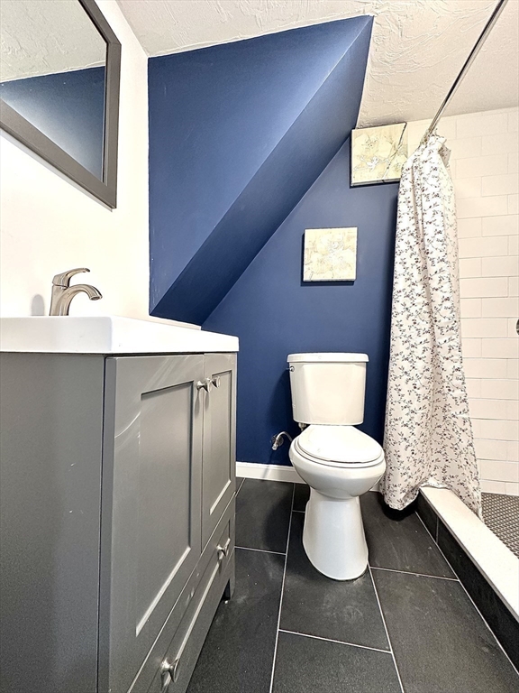 23 Drew Road, Unit 23 Belmont, MA 02478 - Photo 15 of 24 a bathroom with a toilet sink and mirror