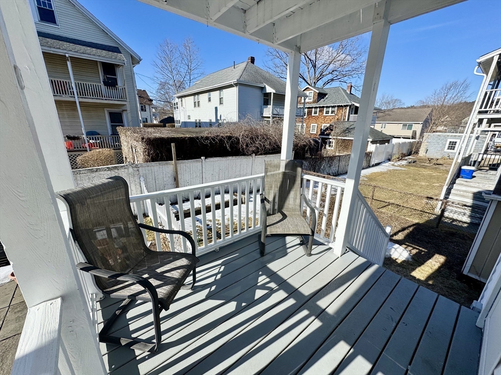 23 Drew Road, Unit 23 Belmont, MA 02478 - Photo 20 of 24 a view of a chairs and table on the deck