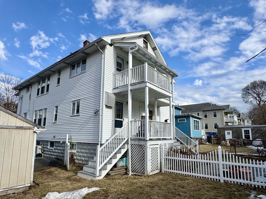 23 Drew Road, Unit 23 Belmont, MA 02478 - Photo 23 of 24 a front view of a house with a yard