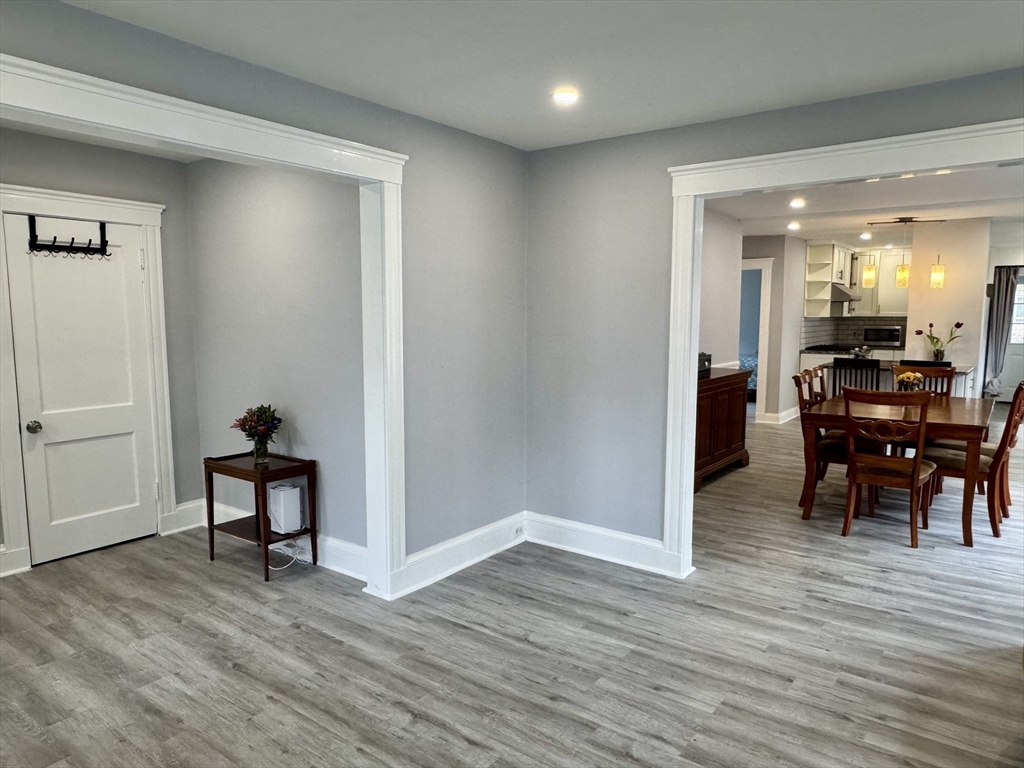 23 Drew Road, Unit 23 Belmont, MA 02478 - Photo 3 of 24 a view of a dining room with furniture and wooden floor