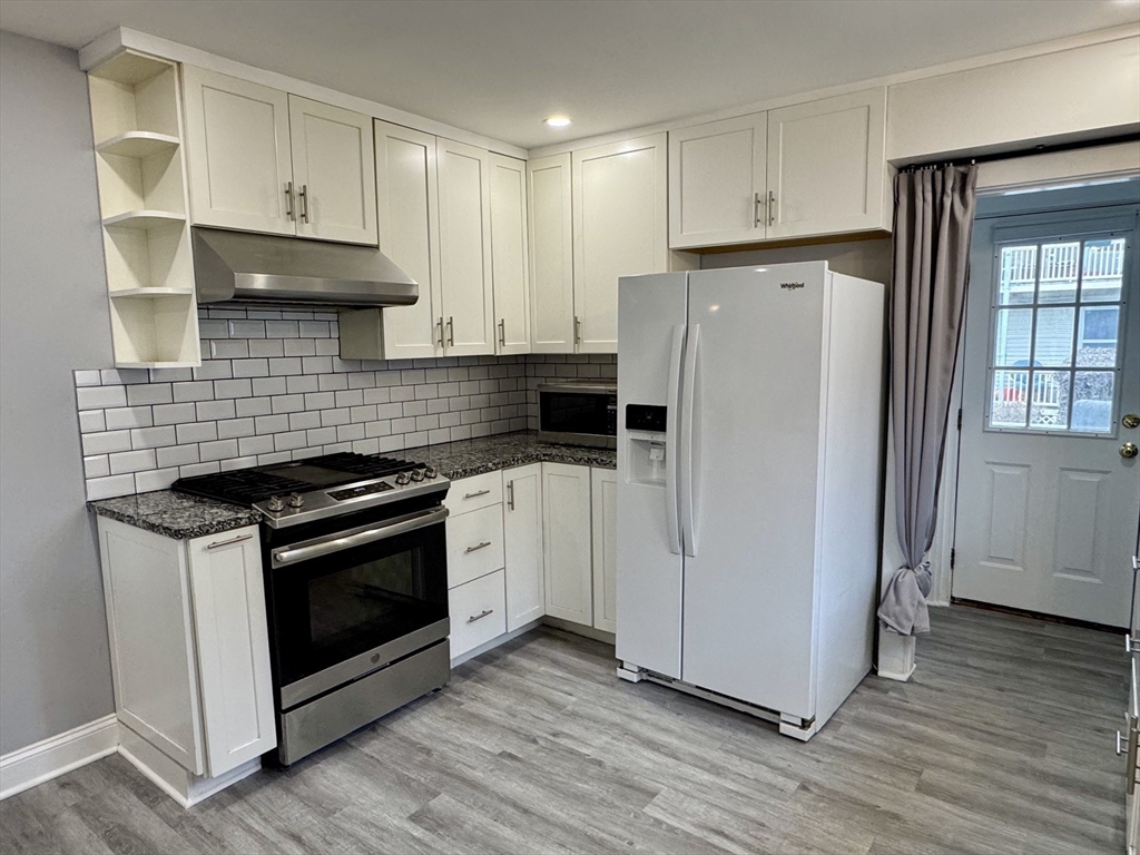 23 Drew Road, Unit 23 Belmont, MA 02478 - Photo 8 of 24 a kitchen with a stove a refrigerator and a sink