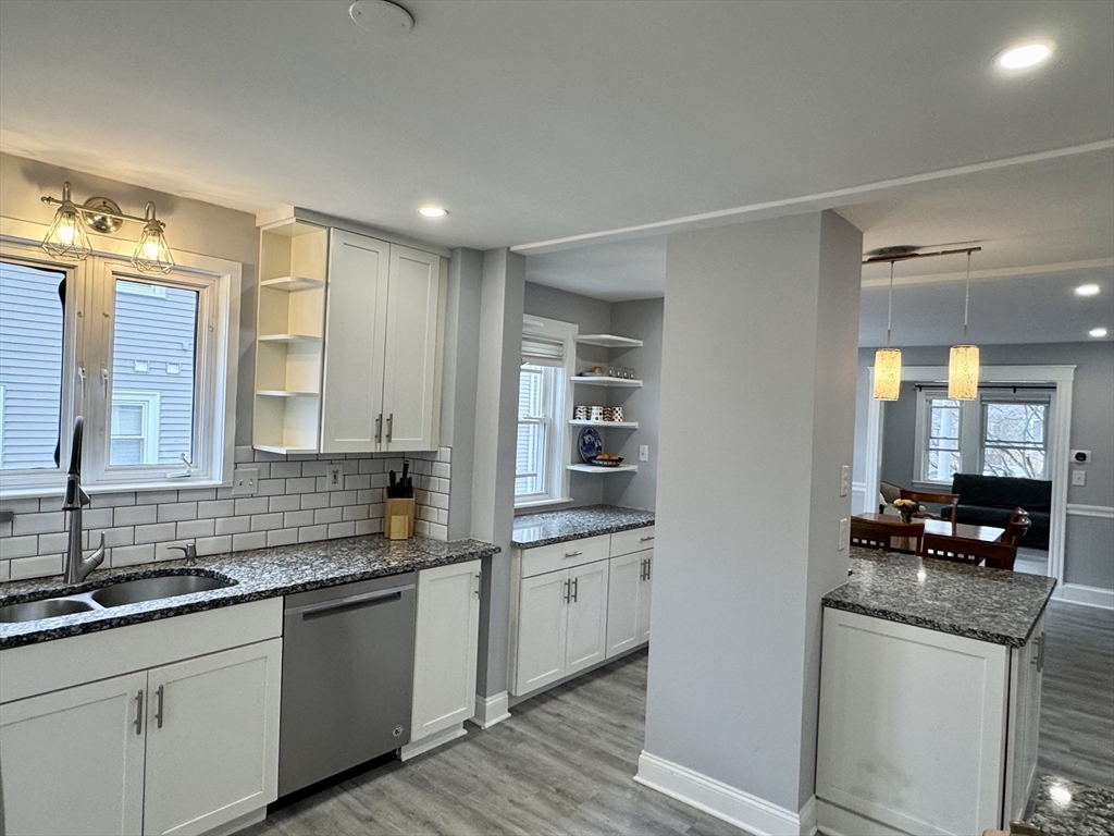 23 Drew Road, Unit 23 Belmont, MA 02478 - Photo 9 of 24 a kitchen with granite countertop a sink and a stove
