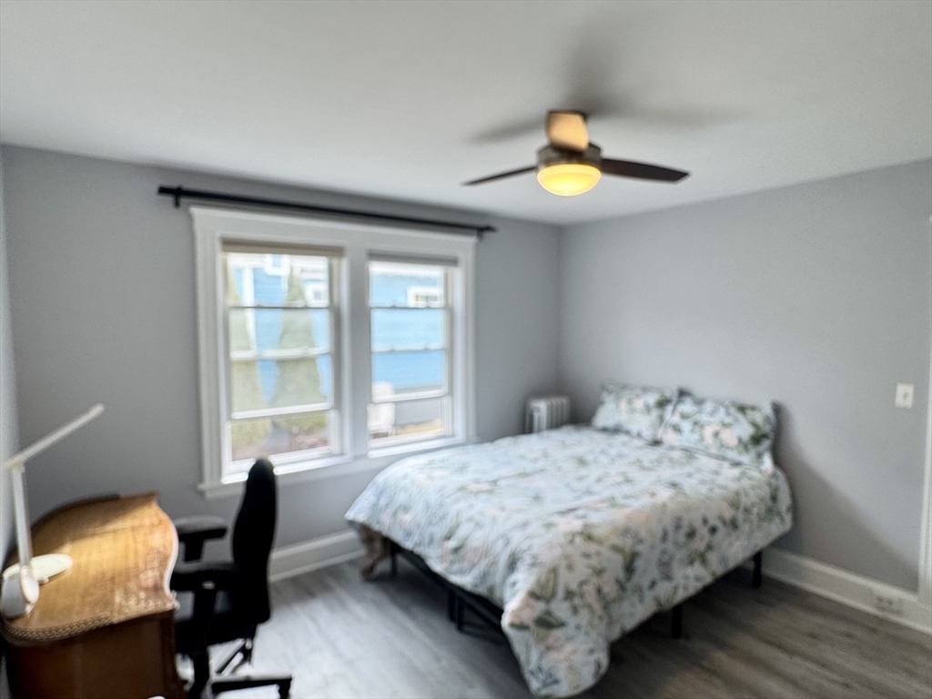 23 Drew Road, Unit 23 Belmont, MA 02478 - Photo 10 of 24 a bedroom with a bed and a chandelier