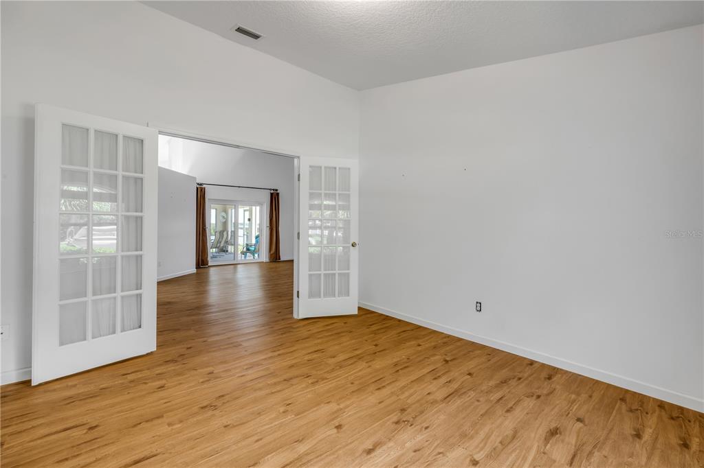 192 Azalea Road Edgewater, FL 32141 - Photo 44 of 94 an empty room with wooden floor and windows