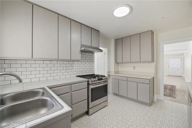 a kitchen that has a sink and a stove