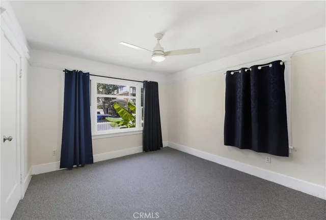 an empty room with windows and closet