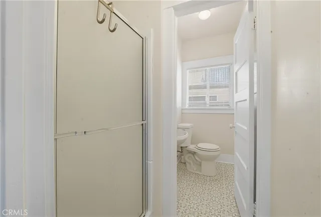 a bathroom with a sink toilet and a mirror