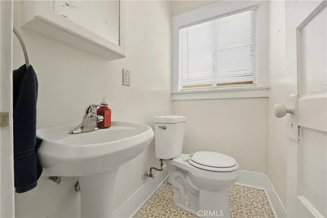 a bathroom with a sink toilet and a mirror