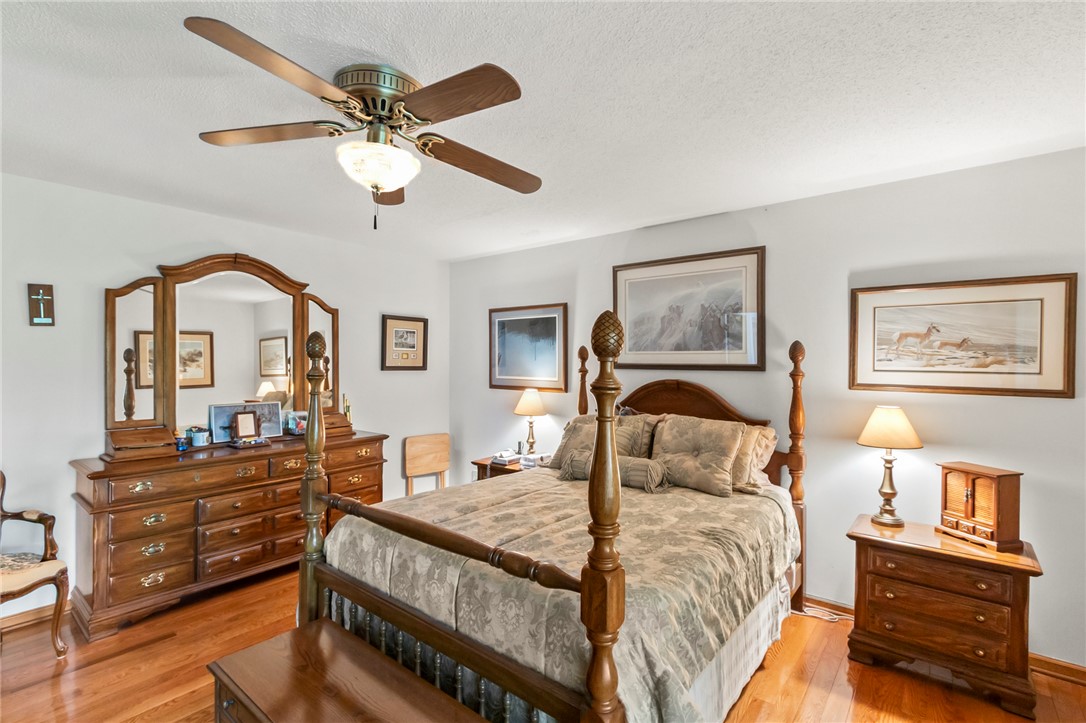 202 Plantation Point Anderson, SC 29625 - Photo 26 of 48 Hardwood flooring extends throughout this naturally illuminated bedroom, complete with a traditional ceiling fan.