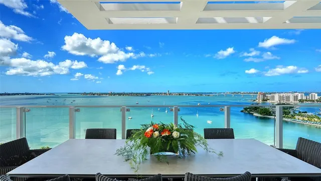 a view of a lake with couches chairs and table