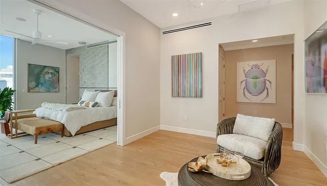a bedroom with furniture and wooden floor