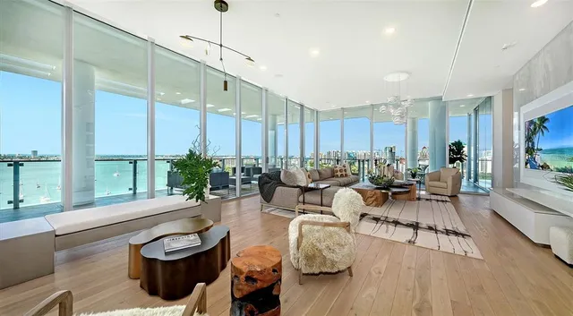 a living room with lots of furniture and a large window