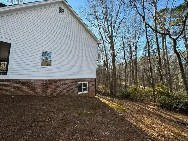 a view of a backyard with large tree