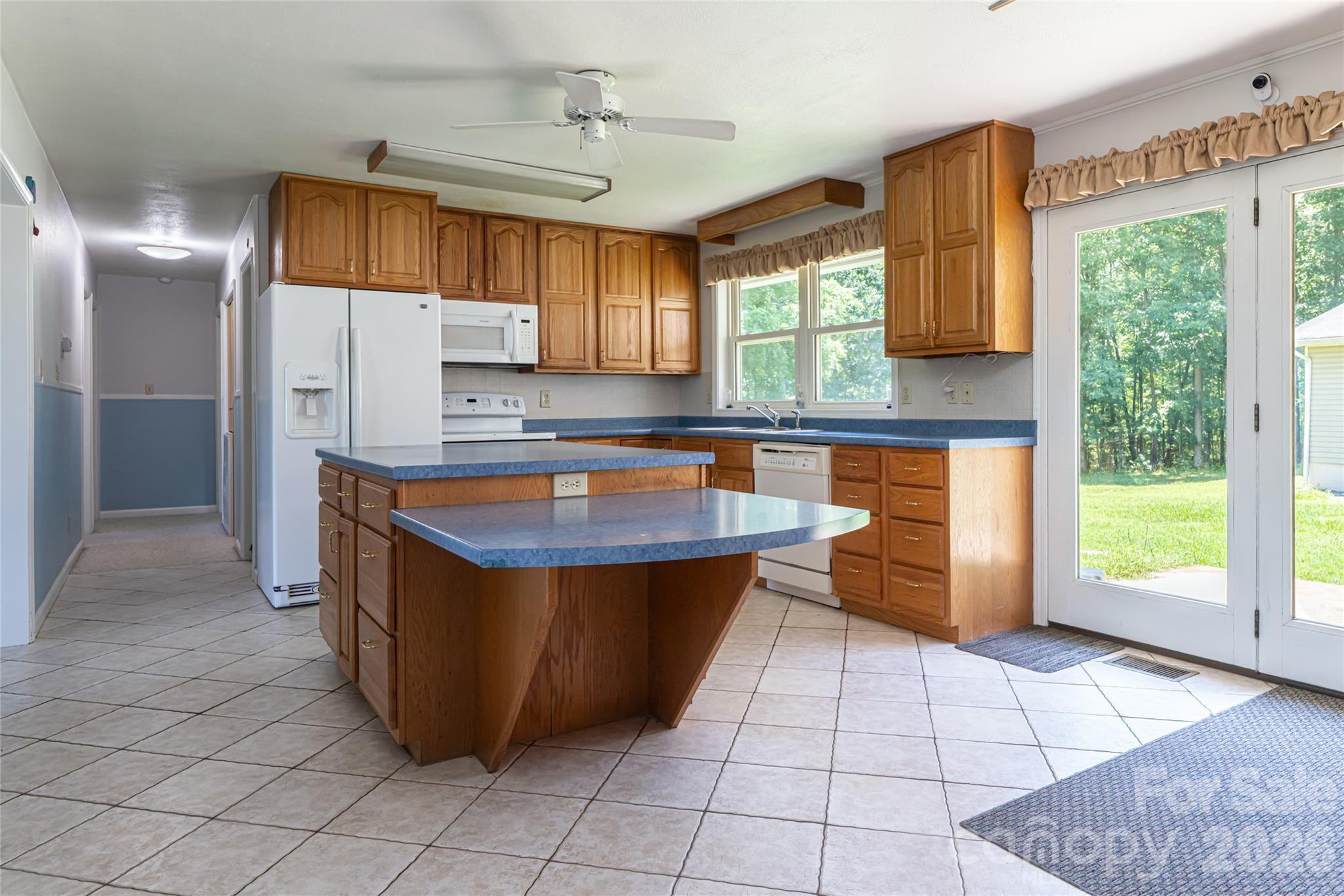 2800 Coxe Road Tryon, NC 28782 - Photo 7 of 40 a kitchen with stainless steel appliances granite countertop a stove a sink and a microwave