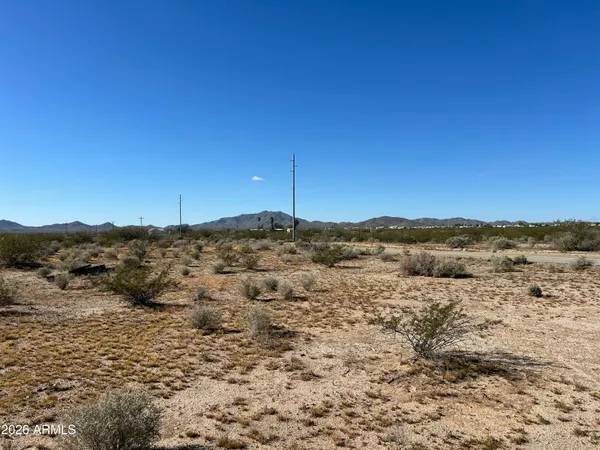a view of a large mountain with a mountain in the background