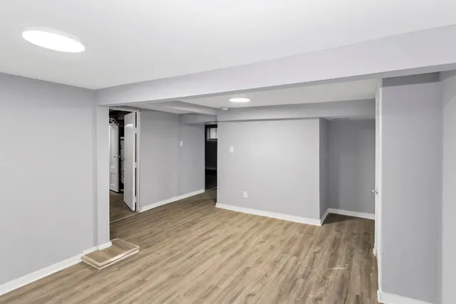 a view of an empty room with wooden floor