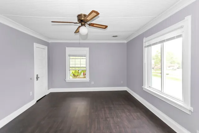 wooden floor in an empty room with a window